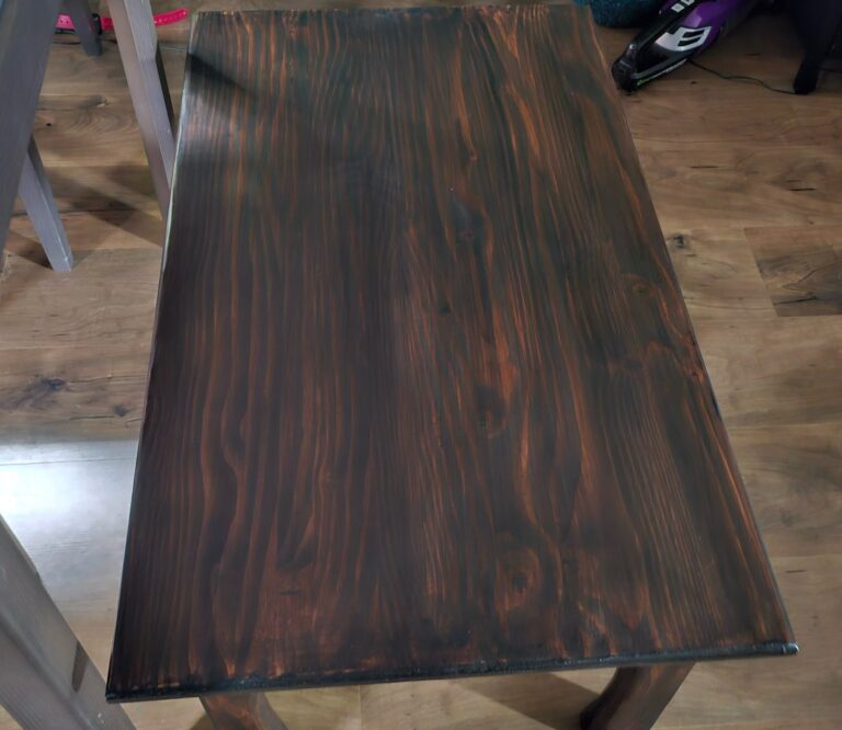 Top of a handmade coffee table with a dark hand-rubbed stain showing the wood grain