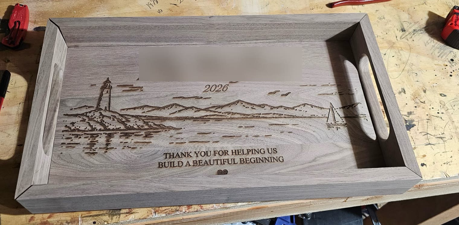 Close-up of laser engraving on a black walnut board
